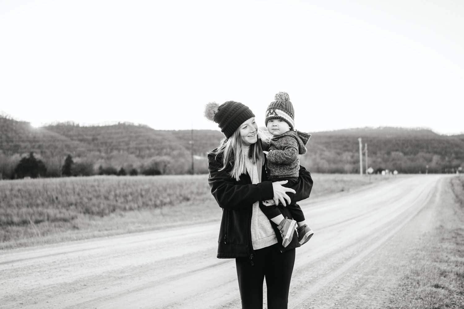 Adirondack Photography A Mom Holding Her Child On A Dirt Road For A Photoshoot