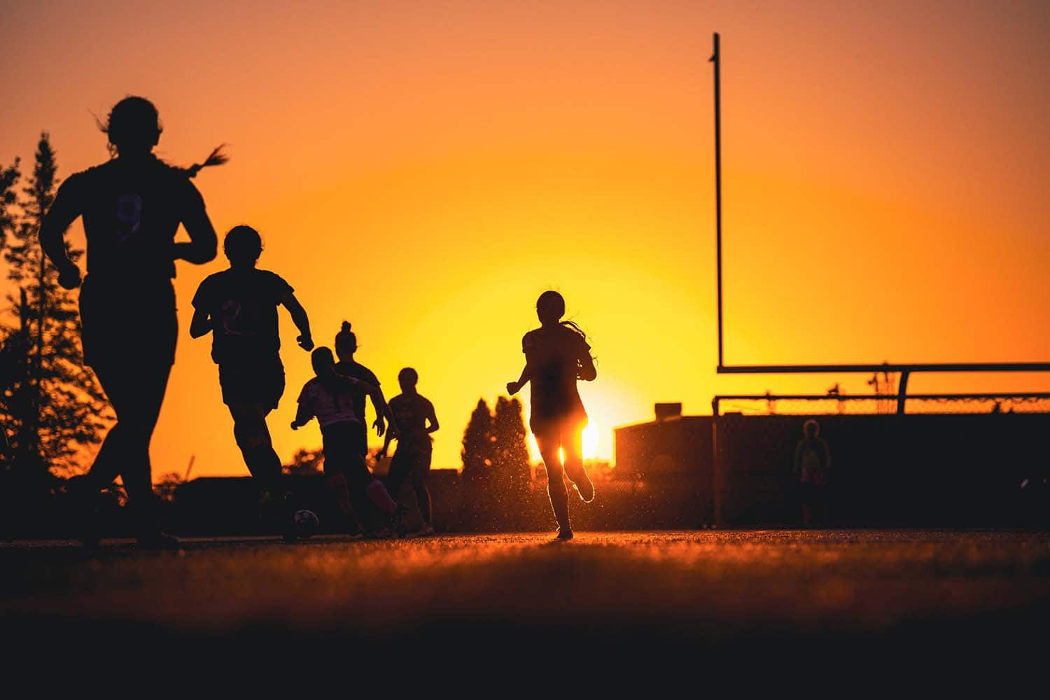 Adirondack Photography A Group Of People Running At Sunset.