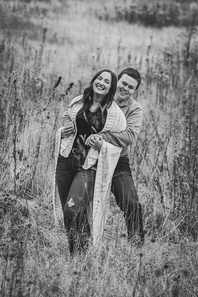 Adirondack Photography A Couple In A Field During Their Engagement Session.