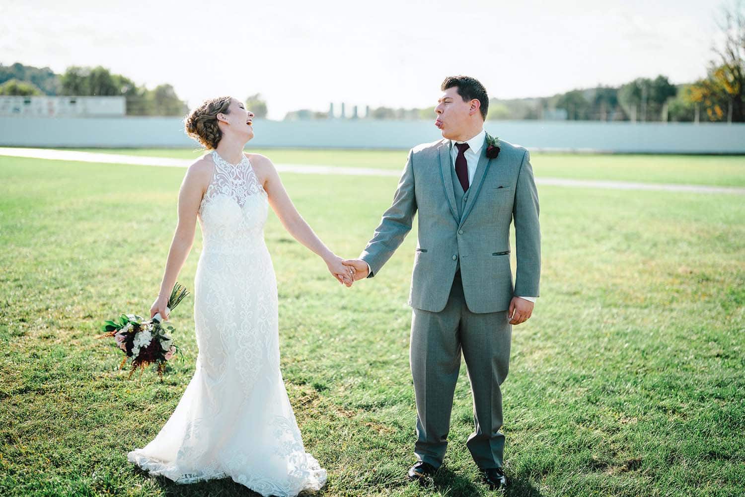 Adirondack Photography A Bride And Groom Holding Hands And Kissing